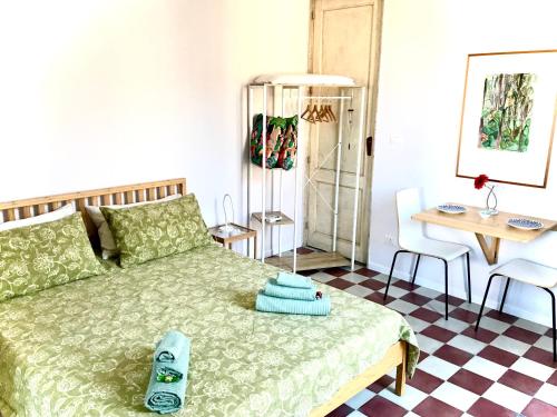 a bedroom with a bed and a table and chairs at Il giardino delle zagare - miniappartamento tra Etna e mare in Riposto