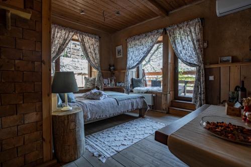 a bedroom with a bed and a large window at Guest House Old Boys in Krasnaya Polyana