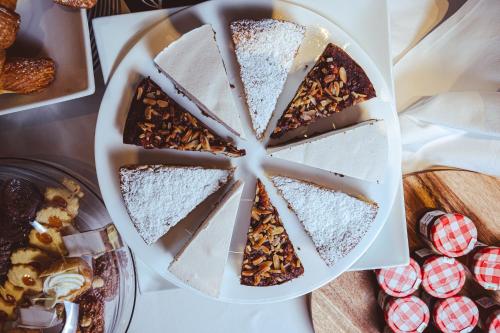 a cake with a tie on a plate on a table at Hotel Morgana in Mendrisio