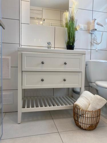 a white bathroom with a sink and a toilet at Domek MAYA Górska Chata in Białka Tatrzańska