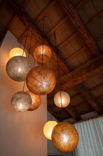 a bunch of lights hanging from a ceiling at Borghetto San Biagio Relais Agriturismo in Thiene