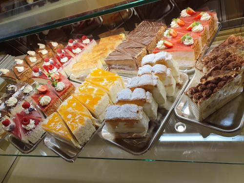 a display case with different types of cakes and pastries at Pension-Cafe-Konditorei Mikl in Hallein