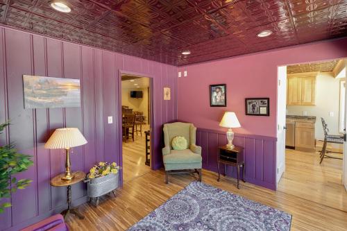 a purple room with a chair and a table at Whitefish Lake Home with Heated Indoor Pool in Manhattan Beach
