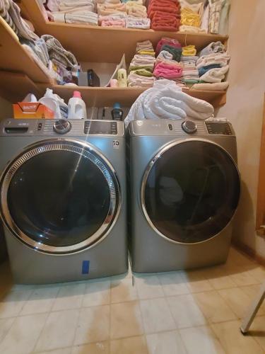 a washing machine and a washer in a closet at Whitefish Lake Home with Heated Indoor Pool in Manhattan Beach