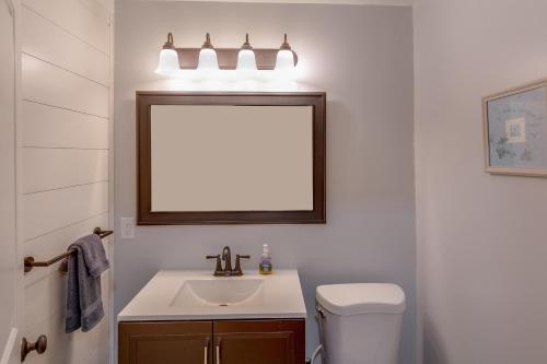 a bathroom with a sink and a mirror and a toilet at Whitefish Lake Home with Heated Indoor Pool in Manhattan Beach