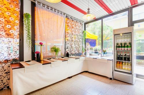 a drink station in a restaurant with a refrigerator at Hotel Canova in Lido di Jesolo