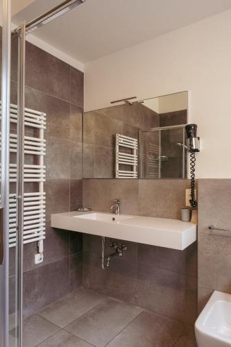 a bathroom with a sink and a mirror at Hotel Morgana in Mendrisio