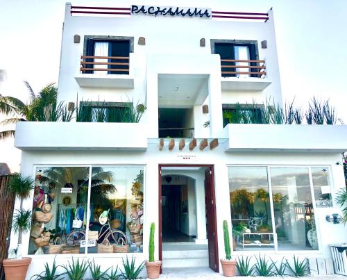 a large white building with a large window at Hotel Boutique Pachamama in Mahahual