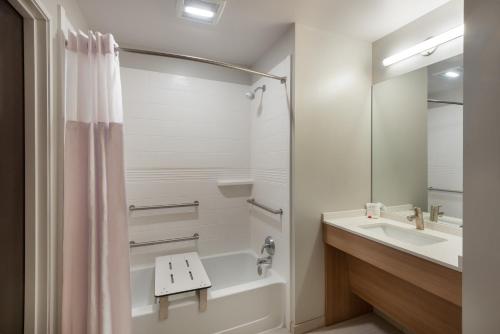 a bathroom with a tub and a sink and a shower at Microtel Inn & Suites by Wyndham Warsaw in Warsaw