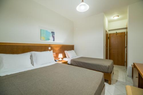 Katil atau katil-katil dalam bilik di Hiona Holiday Hotel