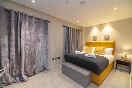 a bedroom with a yellow bed and curtains at Entire 2 Bed - Free Parking - No. 15 - The Cosy Collection Ltd in York