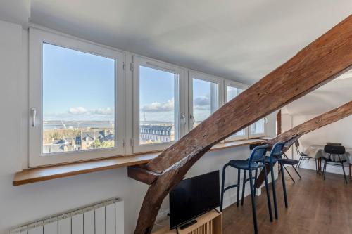 a view from the stairs of a house with windows at Là-Haut - 3 Panorama of the Estuary - City Center in Honfleur