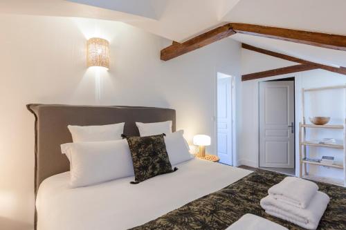 a bedroom with a large white bed with white pillows at Là-Haut - 3 Panorama of the Estuary - City Center in Honfleur