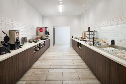 a large kitchen with a long corridor with counters at Staybridge Suites - Auburn - University Area by IHG in Auburn