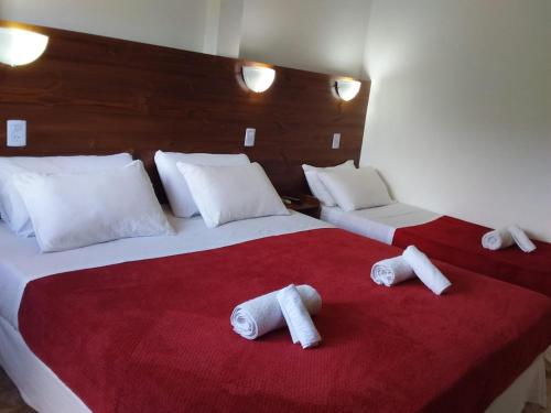 En eller flere senge i et værelse på Hotel La Gran Manzana