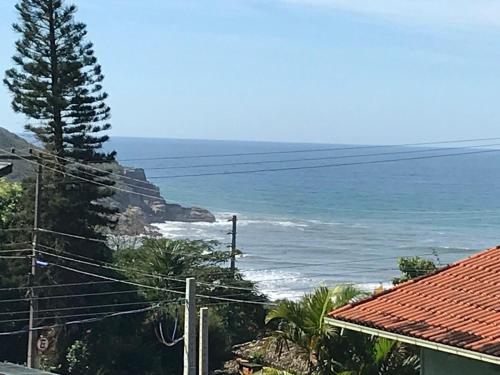 a view of the ocean from a house at Pousada Las Piedras in Praia do Rosa