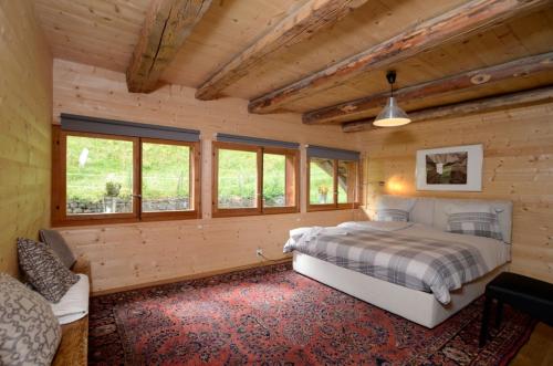 a bedroom with a bed in a wooden cabin at Spacious Swiss Alpine Chalet for Nature Lovers in Val dʼIlliez