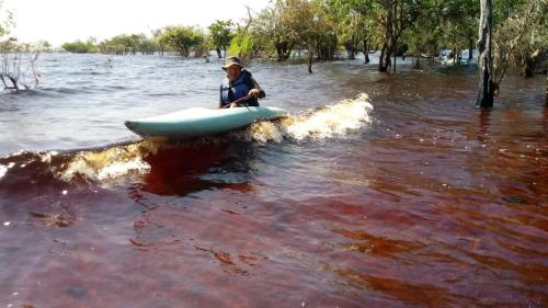 a man riding a boat in the water at Amazônia LODGE Exxperience in Manaus