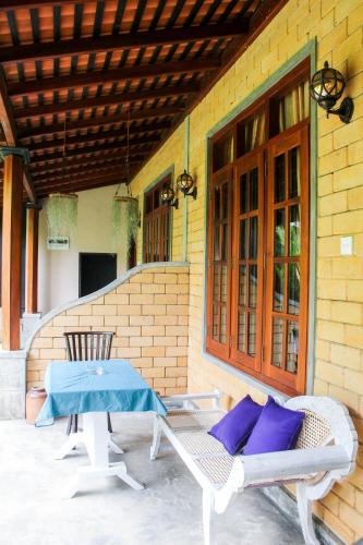 a patio with a table and chairs on a building at DANDELION - Unawatuna in Unawatuna