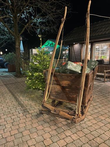 a wooden chair sitting on top of a patio at Gasthaus Eickholt GmbH in Ascheberg