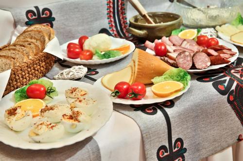 a table with plates of food on a table at Willa Jarząbek - 5 min do term Szaflary I Gorący Potok in Szaflary