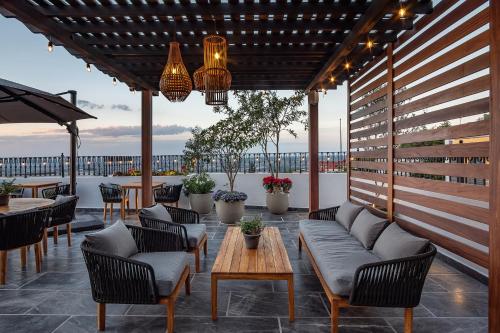 a patio with couches and chairs and a table at Hotel Casa Arum in San Miguel de Allende
