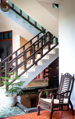 a rocking chair sitting next to a stair case at DANDELION - Unawatuna in Unawatuna