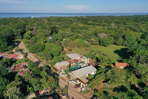 an aerial view of a house in the middle of a forest at Cafe Playa Negra Hotel in Playa Negra