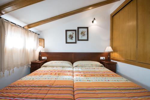 a bedroom with a large bed with two night stands at Casa rural Vista Alegre , cerca de Valencia y Castellón in Caudiel