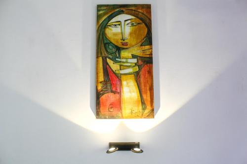 a painting of a woman is on display in a museum at DANDELION - Unawatuna in Unawatuna