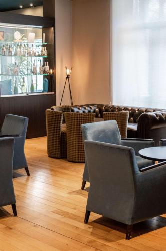 a restaurant with chairs and tables in a room at Radisson BLU Balmoral in Spa