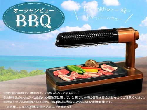 a barbecue grill with meat and vegetables in a tray at Katsuren Seatopia 勝連シートピア in Uruma