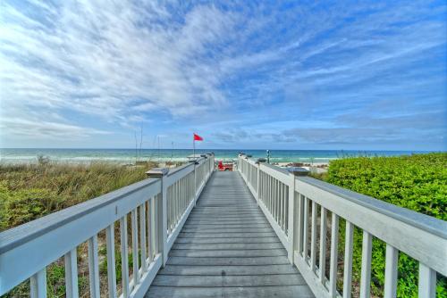 a boardwalk leading to the beach with a red flag at PierPark Cozy Condo w View Sterling Breeze Resorts in Panama City Beach