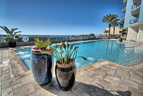a swimming pool with two large pots with plants in it at PierPark Cozy Condo w View Sterling Breeze Resorts in Panama City Beach