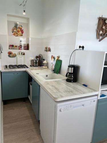 a kitchen with a sink and a counter top at Ti Cabanon. Appartement vue mer à Deshaies. in Deshaies