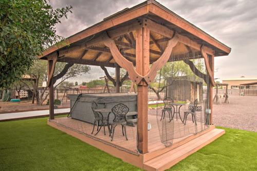 a wooden gazebo with chairs and a grill at Phoenix Kick Back Corral with Outdoor Oasis! in Anthem
