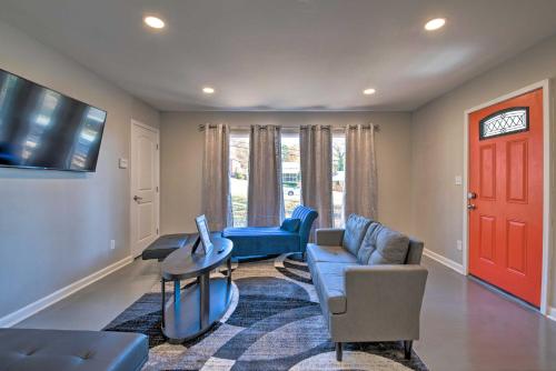 a living room with a blue couch and a red door at Central Location! World Cup ATL HQ 5 Mi to Stadium in Atlanta