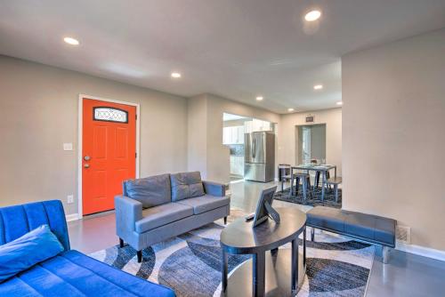 a living room with a blue couch and a red door at Central Location! World Cup ATL HQ 5 Mi to Stadium in Atlanta