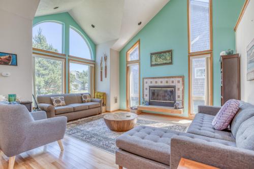 a living room with two couches and a fireplace at Sand Dollar Find - Meredith Lodging in Pacific City