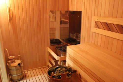 a small room with a stove in a wooden cabin at Sanatoriy Imeni Anzhievskogo - Korpus Villa German in Essentuki