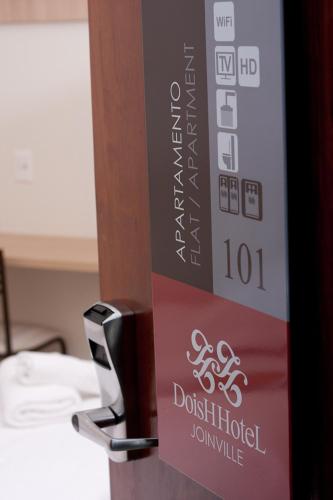 a sign for a ddestinatedulumulumulumulum at Hotel Dois H in Joinville
