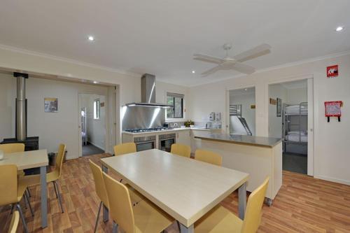 a kitchen and dining room with a table and chairs at Tahune AirWalk Cabin and Lodge in Geeveston