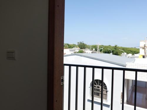 a balcony with a view of a building at Summerflow Hostel in Xiaoliuqiu