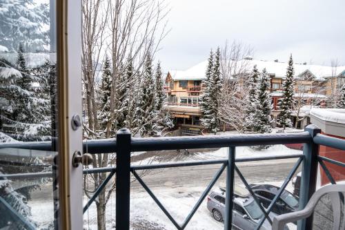a balcony with a view of a snow covered yard at Alpenglow Lodge by MVA in Whistler