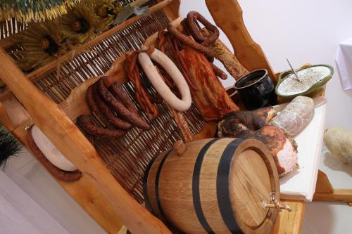a tray of food with sausage and a barrel at Hotel Stara Fabryka in Małogoszcz