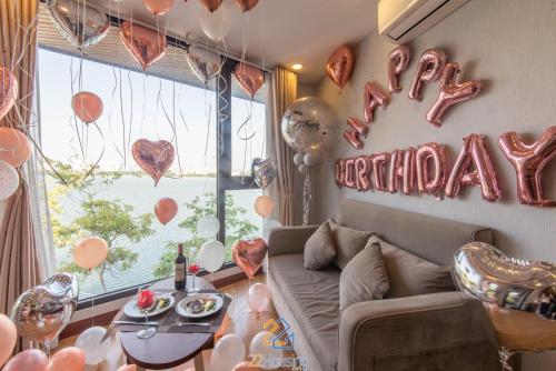 a living room with a couch and a happy birthday sign at 22Land Moon West Lake in Hanoi