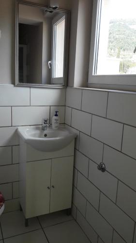 a white bathroom with a sink and a mirror at Bed and Breakfast BLUE in BLUE, Room GREEN + in Komiža