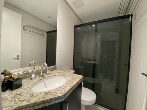 La salle de bains est pourvue d'un lavabo, d'une douche et de toilettes. dans l'établissement Akile Peixoto Gomide, à São Paulo