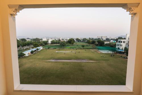 a view of a field from a window in a building at Vasant Vilas in Udaipur