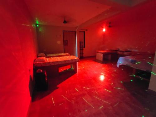 an empty room with red lights on the floor at Godwill Kimo Guest house Seraulim in Madgaon